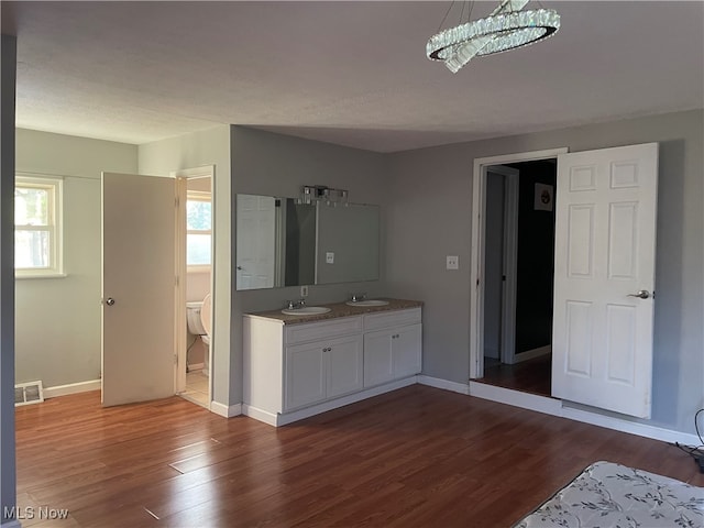 bathroom featuring vanity, toilet, and hardwood / wood-style flooring