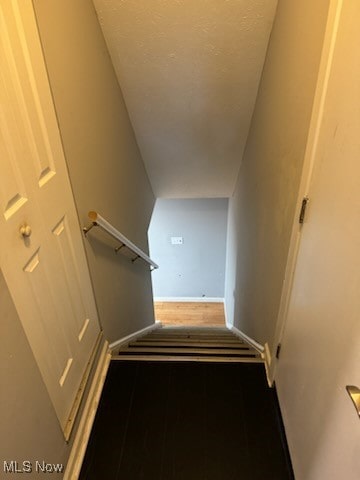 stairs featuring hardwood / wood-style floors