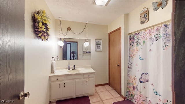 bathroom featuring vanity, curtained shower, and a textured ceiling