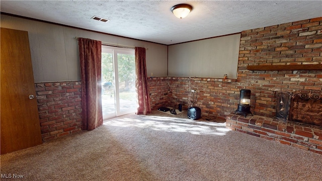 unfurnished living room with a textured ceiling, carpet floors, and wooden walls