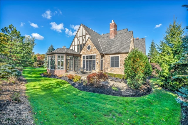 39470 Stillman Ln, Willoughby, OH 44094 - rear view of house featuring a patio, a lawn, and a sunroom