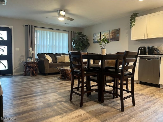 dining area with light hardwood / wood-style floors and ceiling fan