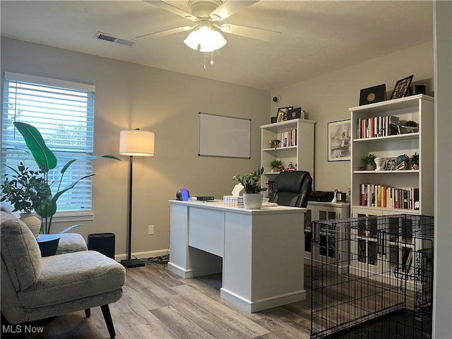 office space featuring light wood-type flooring and ceiling fan