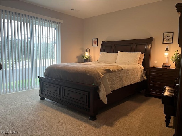 bedroom featuring light colored carpet and access to outside