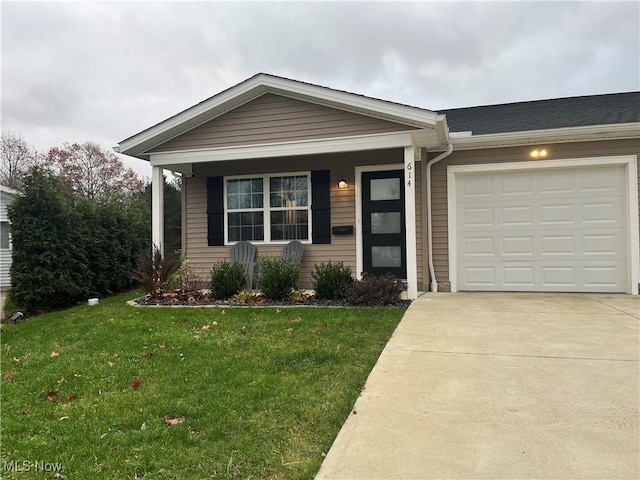 view of front of home with a garage and a front lawn