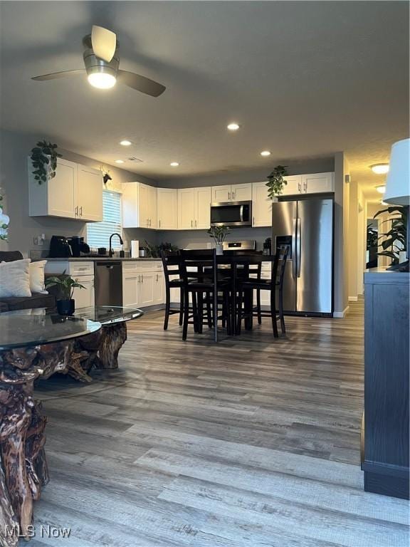 dining space with dark hardwood / wood-style floors and ceiling fan