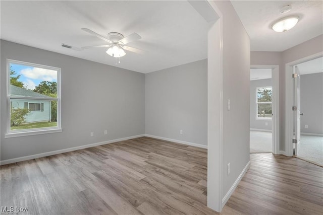 spare room with light hardwood / wood-style flooring and ceiling fan