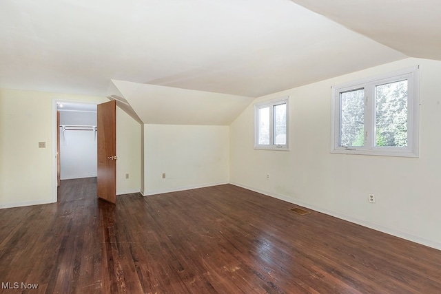 bonus room featuring lofted ceiling and dark hardwood / wood-style flooring