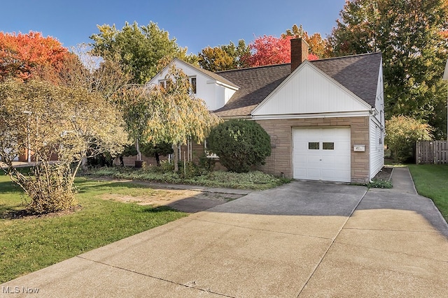 view of front of house with a front yard and a garage