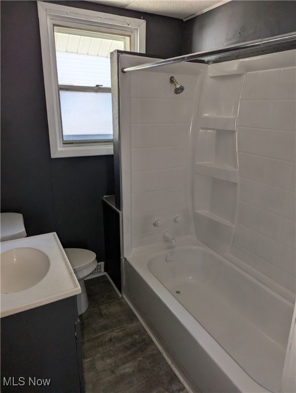 full bathroom with toilet, shower / bathing tub combination, hardwood / wood-style flooring, and vanity