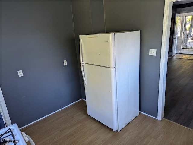 kitchen with hardwood / wood-style floors and white fridge