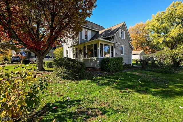 view of home's exterior with a yard