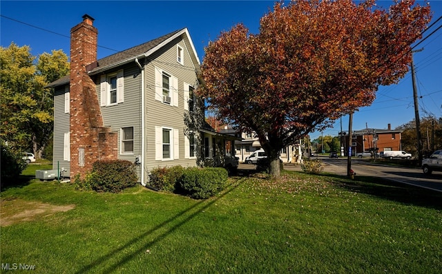 view of side of property featuring a yard