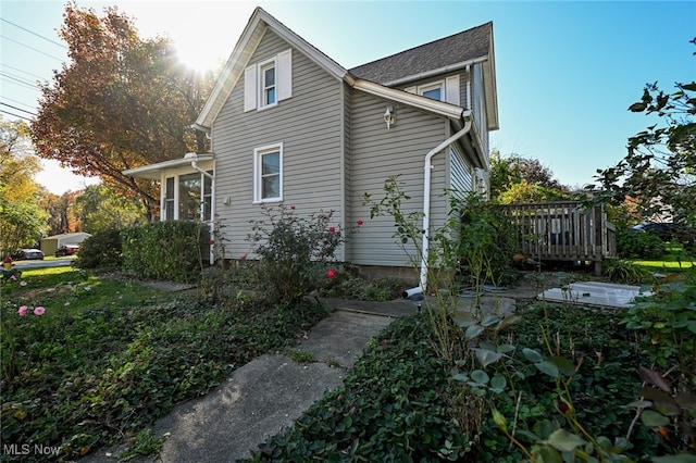 view of home's exterior featuring a wooden deck