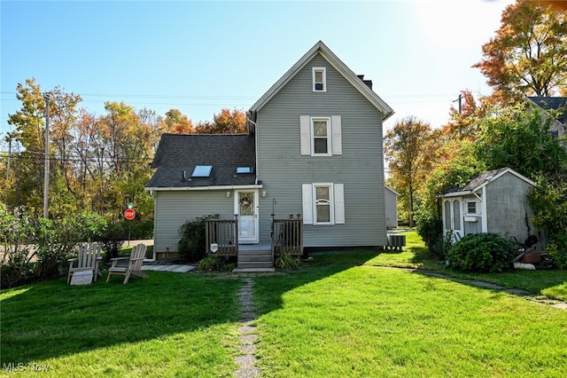 back of house featuring a wooden deck, a storage shed, a yard, and central AC unit