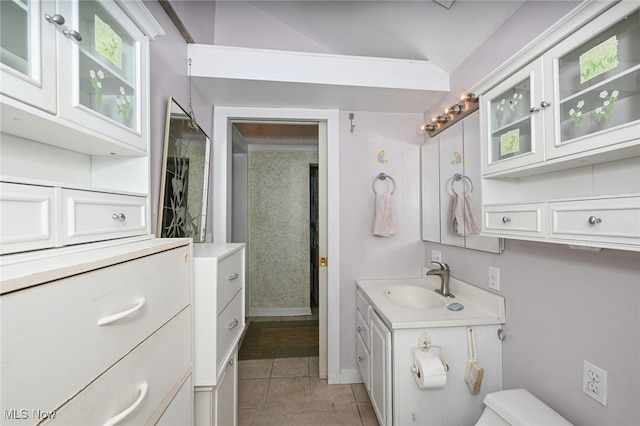 bathroom with vanity, toilet, and tile patterned floors