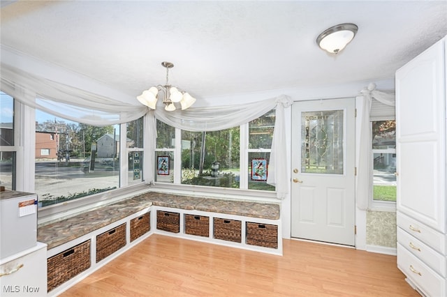 unfurnished sunroom featuring a notable chandelier