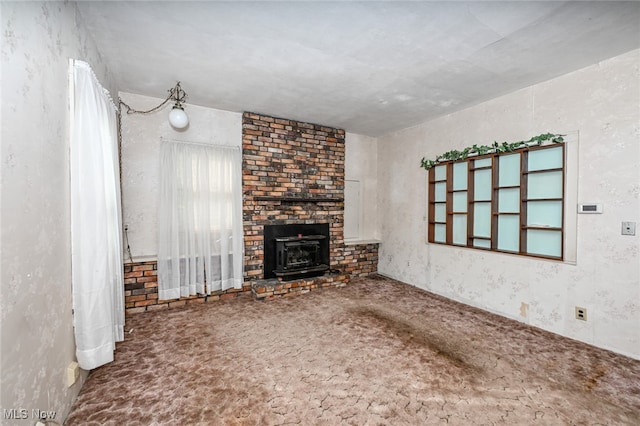 unfurnished living room featuring a wood stove