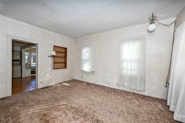 unfurnished room with dark hardwood / wood-style floors and a healthy amount of sunlight