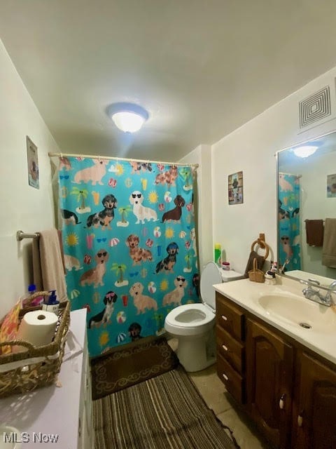 bathroom with vanity, a shower with curtain, toilet, and tile patterned flooring