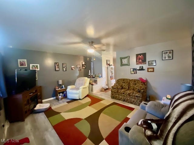 living room featuring hardwood / wood-style floors and ceiling fan