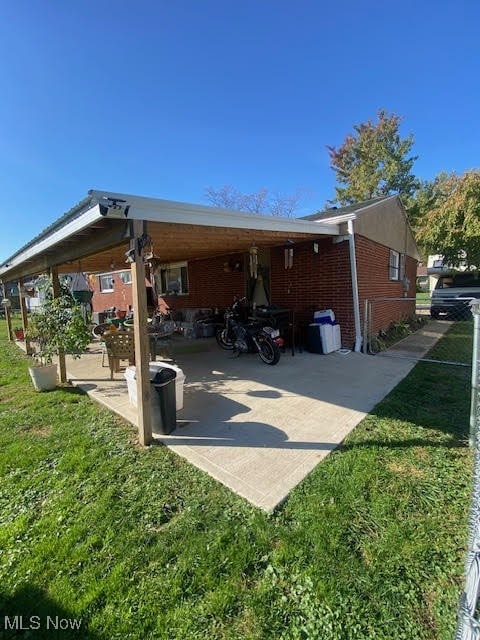 exterior space with a lawn and a carport