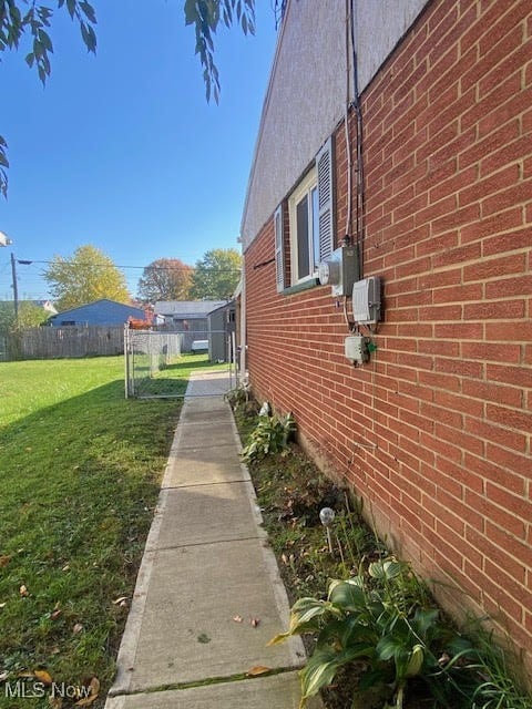 view of side of home with a yard