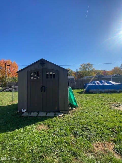 view of outbuilding featuring a lawn