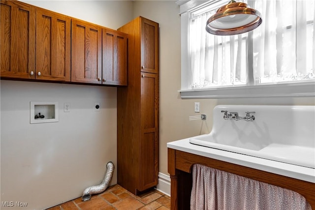 washroom featuring hookup for a washing machine, cabinets, and hookup for an electric dryer