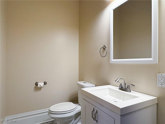 bathroom featuring toilet and vanity