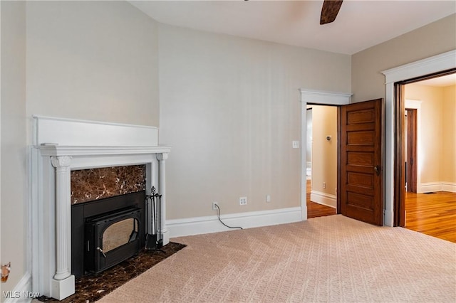 unfurnished living room with ceiling fan and carpet floors