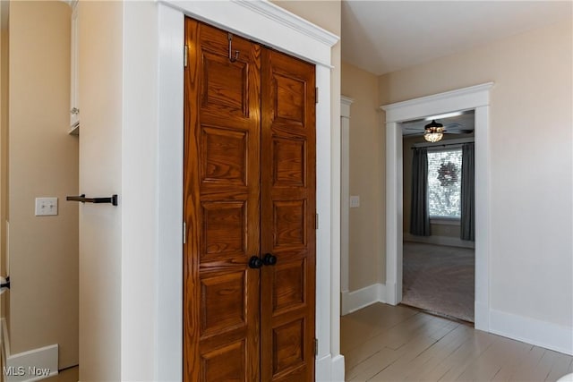 corridor with light hardwood / wood-style flooring