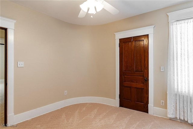 unfurnished bedroom with ceiling fan, carpet flooring, and multiple windows