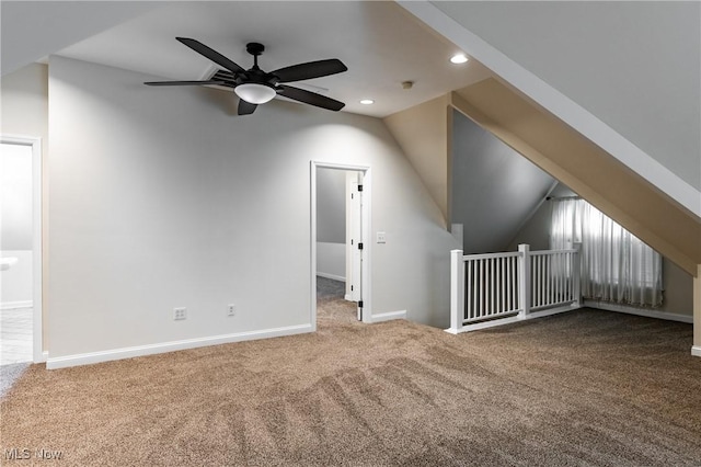 additional living space featuring ceiling fan, carpet, and lofted ceiling