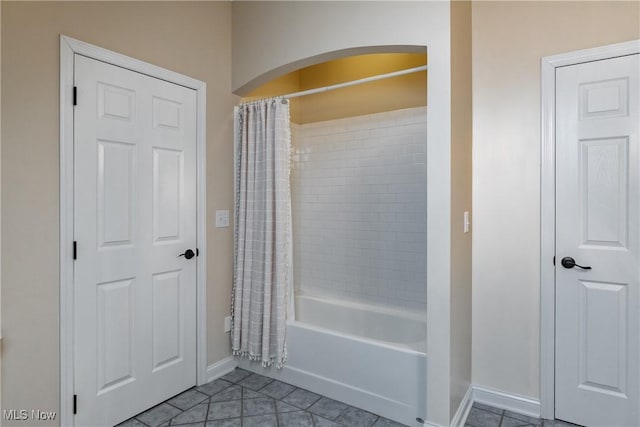 bathroom featuring tile patterned floors and shower / bath combo with shower curtain