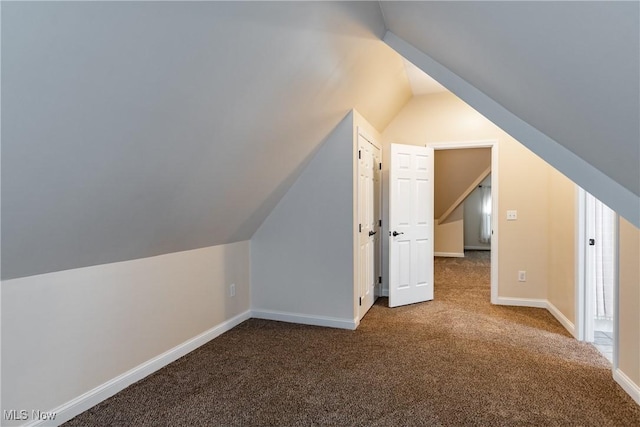 bonus room with carpet floors and lofted ceiling