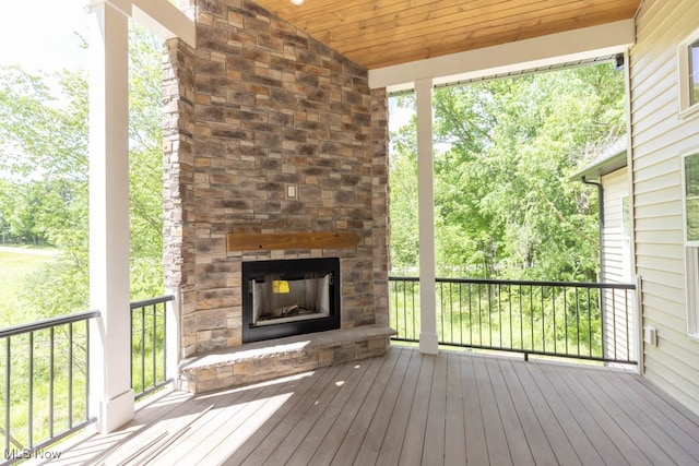 deck featuring an outdoor stone fireplace