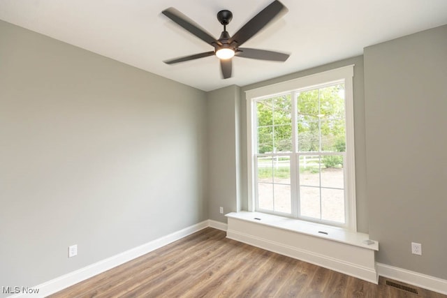 empty room featuring ceiling fan and hardwood / wood-style floors