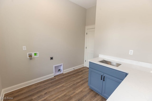 laundry area with cabinets, dark wood-type flooring, sink, hookup for a washing machine, and hookup for an electric dryer