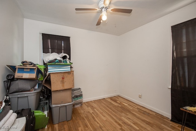 interior space with ceiling fan