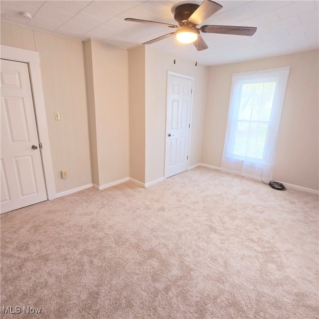 empty room with light colored carpet and ceiling fan