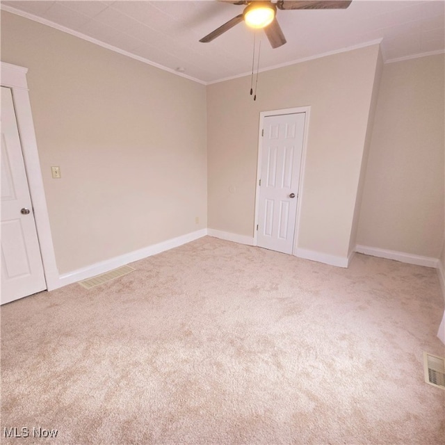 unfurnished room featuring crown molding and carpet floors