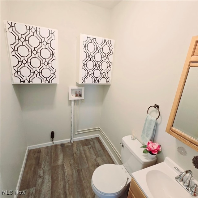 bathroom with vanity, wood-type flooring, and toilet