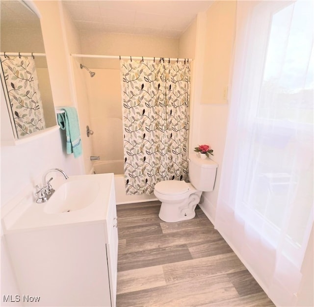 full bathroom with vanity, toilet, hardwood / wood-style flooring, and shower / bath combo