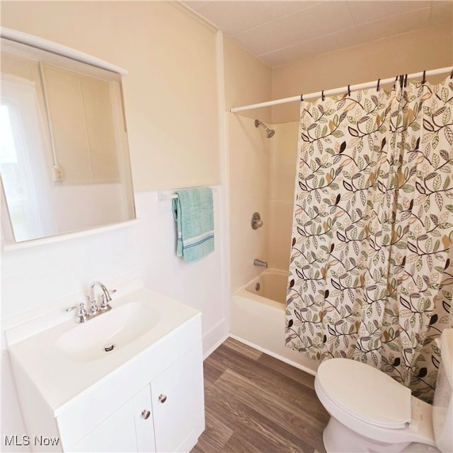 full bathroom with vanity, shower / bath combo, wood-type flooring, and toilet