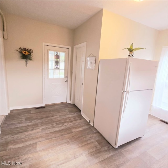 entryway with light hardwood / wood-style floors