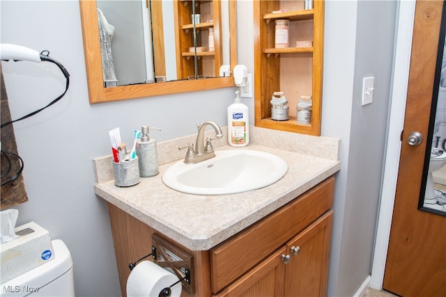 bathroom featuring vanity and toilet