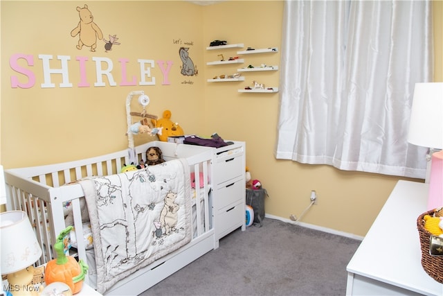 bedroom featuring light colored carpet and a nursery area