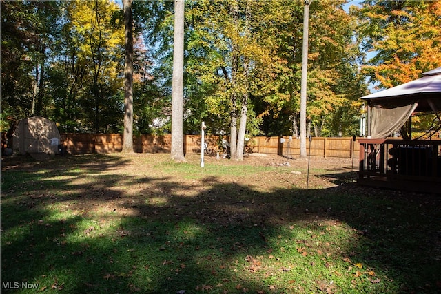 view of yard with a gazebo and a storage unit