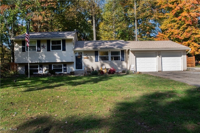 tri-level home featuring a garage and a front lawn